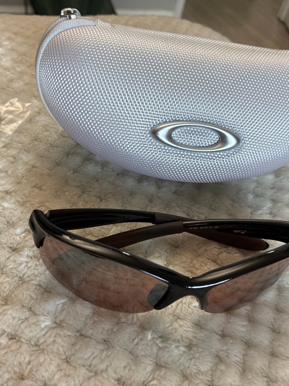 Oakley Men’s Black Frame Sunglasses with Brown Lenses and Silver Case
